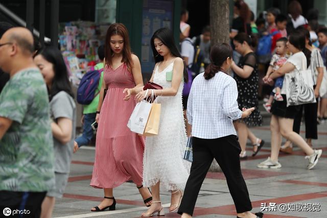 重庆一广场商圈熙来攘往，美女帅哥千姿百态，道路好像成了走秀台